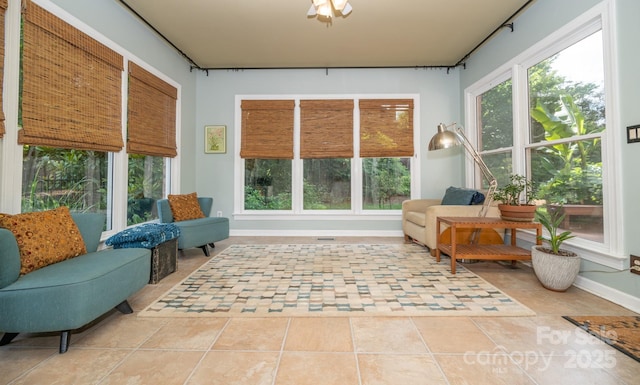 sunroom / solarium featuring baseboards