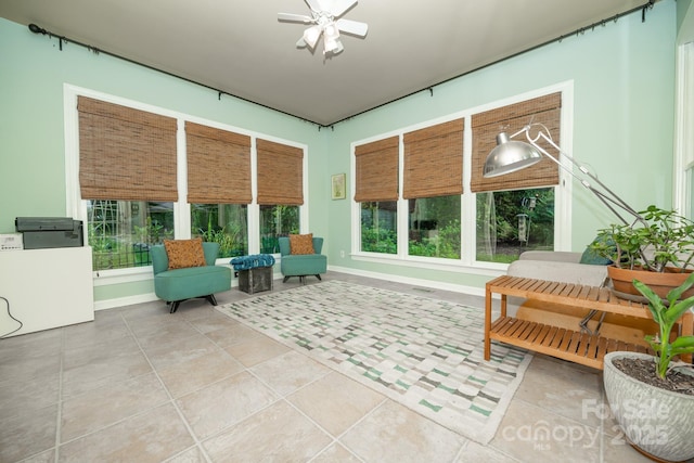 sunroom / solarium featuring plenty of natural light, baseboards, and tile patterned flooring