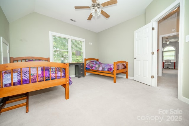 carpeted bedroom featuring lofted ceiling, baseboards, and a ceiling fan