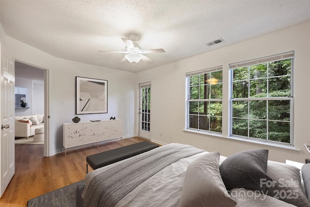 6016 Gray Gate Ln Unit C, Charlotte, NC 28210 - bedroom with wood finished floors, a textured ceiling, baseboards, and a ceiling fan