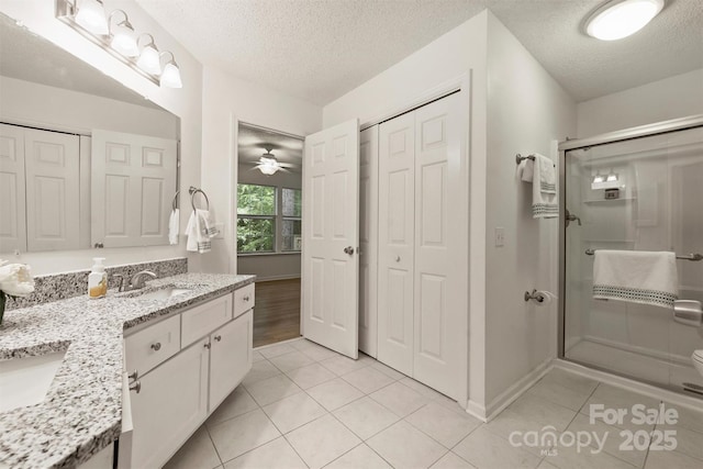 6016 Gray Gate Ln Unit C, Charlotte, NC 28210 - full bath with a closet, double vanity, a stall shower, tile patterned flooring, and a textured ceiling