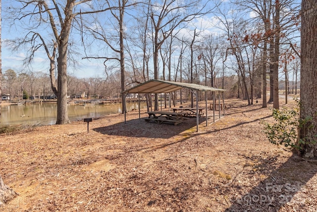 view of yard featuring a carport and a water view