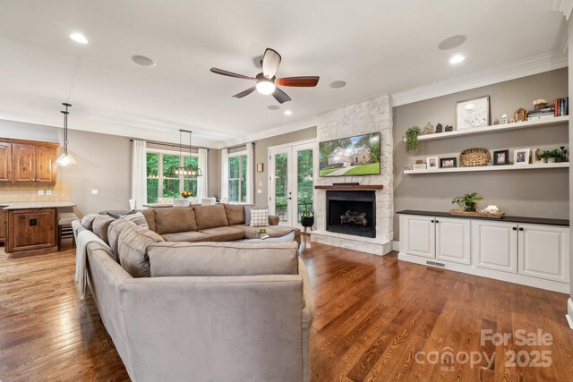 309 Palm Cove Way, York, SC 29745 - living room featuring a ceiling fan, crown molding, a stone fireplace, wood finished floors, and recessed lighting