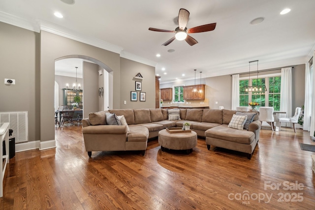 309 Palm Cove Way, York, SC 29745 - living area featuring a chandelier, arched walkways, ceiling fan, crown molding, and dark wood-type flooring