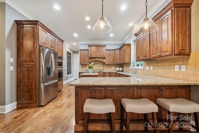 309 Palm Cove Way, York, SC 29745 - kitchen with appliances with stainless steel finishes, a peninsula, ornamental molding, light stone counters, and decorative backsplash