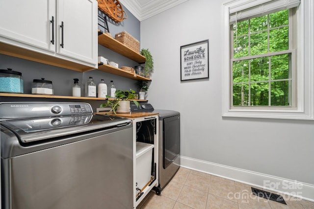 309 Palm Cove Way, York, SC 29745 - laundry room with washer and dryer, cabinet space, crown molding, light tile patterned floors, and baseboards