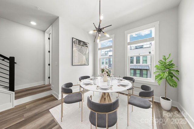 4011 Tundra Rd, Charlotte, NC 28203 - dining space with a chandelier, wood finished floors, baseboards, and stairs