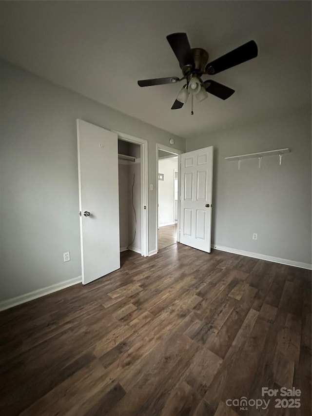 unfurnished bedroom with baseboards, dark wood-style floors, a closet, and ceiling fan