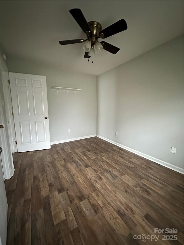 unfurnished bedroom with dark wood-type flooring, baseboards, and a ceiling fan