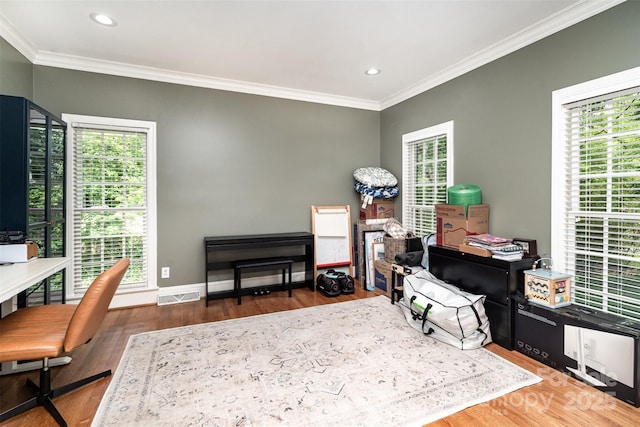 office space featuring ornamental molding, plenty of natural light, wood finished floors, recessed lighting, and baseboards