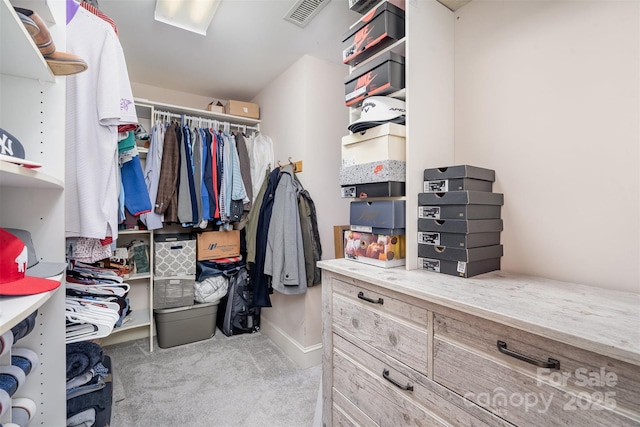 walk in closet featuring carpet flooring