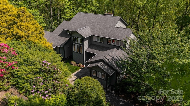 view from above of property featuring a heavily wooded area