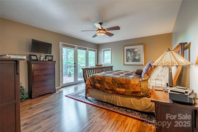 bedroom with access to exterior, wood finished floors, and a ceiling fan