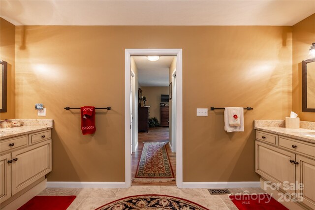 bathroom featuring baseboards, vanity, and tile patterned flooring