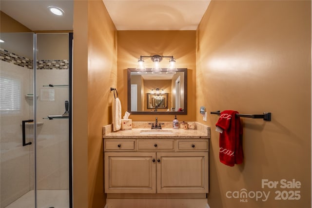 full bathroom with a stall shower and vanity