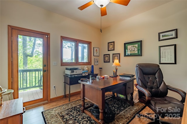 office with a ceiling fan, wood finished floors, and baseboards