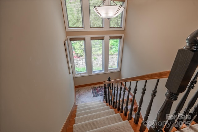 stairway featuring wood finished floors and baseboards