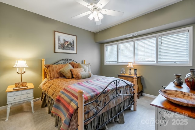 carpeted bedroom with baseboards and a ceiling fan