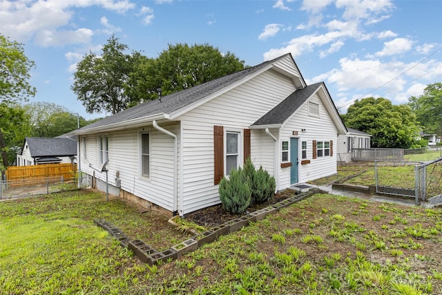417 S Broad St, Gastonia, NC 28052 - view of side of property with a shingled roof and a garden