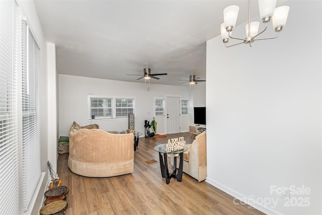 417 S Broad St, Gastonia, NC 28052 - living room with light wood finished floors, a ceiling fan, baseboards, and a chandelier