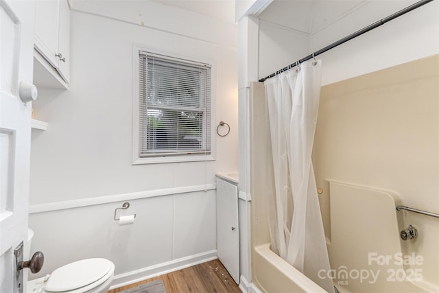 417 S Broad St, Gastonia, NC 28052 - full bathroom with wood finished floors, toilet, shower / bath combo, and baseboards
