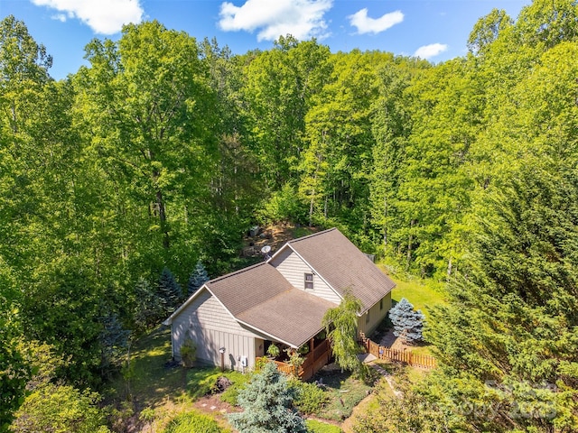 view of subject property featuring a heavily wooded area
