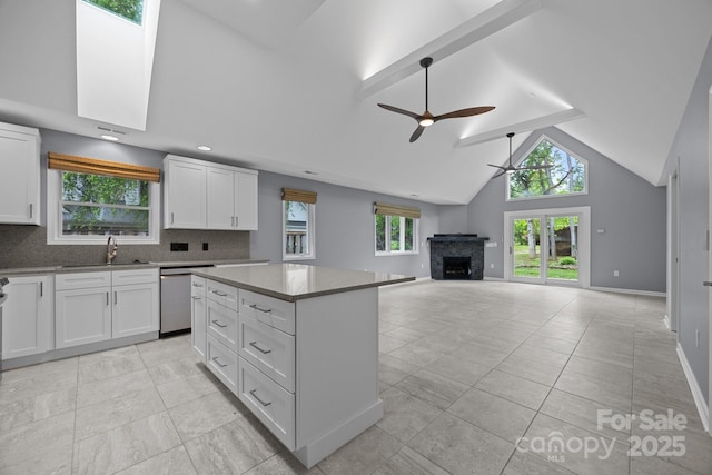 41 Beekeeper Trl, Swannanoa, NC 28778 - kitchen featuring a ceiling fan, a sink, dishwasher, a fireplace, and a kitchen island