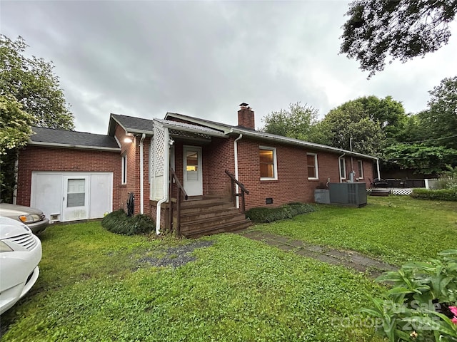 2009 Hickory Grove Rd, Gastonia, NC 28056 - view of front of home with brick siding, a chimney, a front yard, and central AC unit