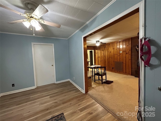 2009 Hickory Grove Rd, Gastonia, NC 28056 - unfurnished room featuring a ceiling fan, ornamental molding, wood finished floors, baseboards, and wood walls