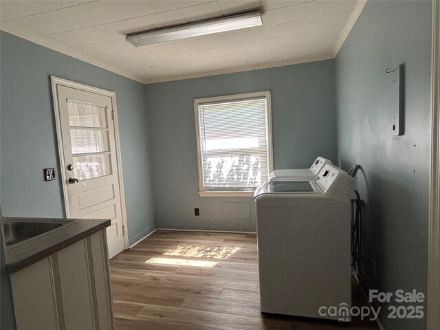 2009 Hickory Grove Rd, Gastonia, NC 28056 - washroom featuring crown molding, washer and dryer, wood finished floors, and a sink