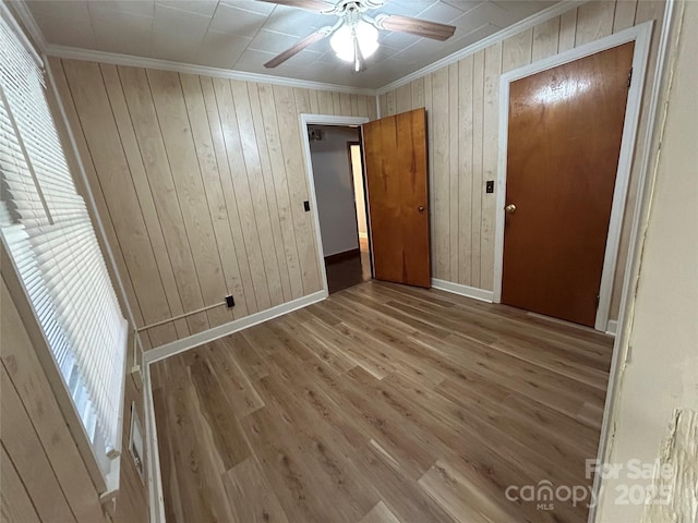 2009 Hickory Grove Rd, Gastonia, NC 28056 - unfurnished room with crown molding, baseboards, wooden walls, wood finished floors, and ceiling fan