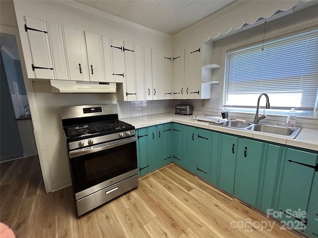 2009 Hickory Grove Rd, Gastonia, NC 28056 - kitchen featuring stainless steel gas range, a sink, under cabinet range hood, light wood finished floors, and green cabinetry