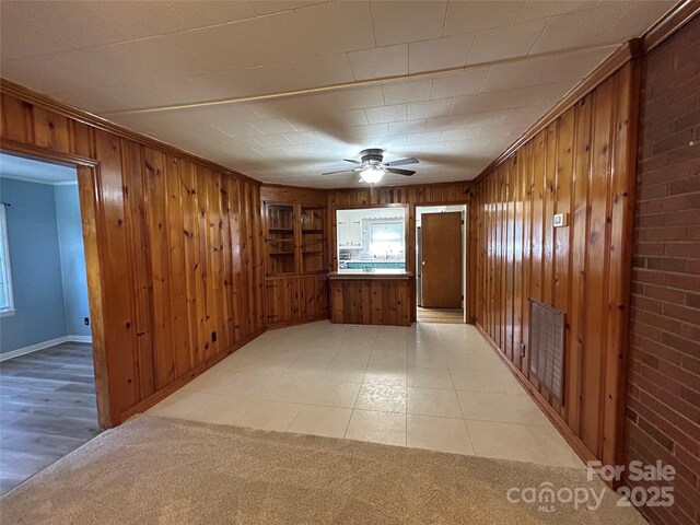 2009 Hickory Grove Rd, Gastonia, NC 28056 - spare room featuring wood walls, a ceiling fan, plenty of natural light, and baseboards