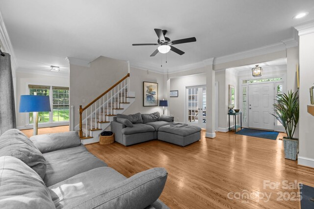327 Wilby Dr, Charlotte, NC 28270 - living area with stairway, light wood-style flooring, ceiling fan, crown molding, and baseboards