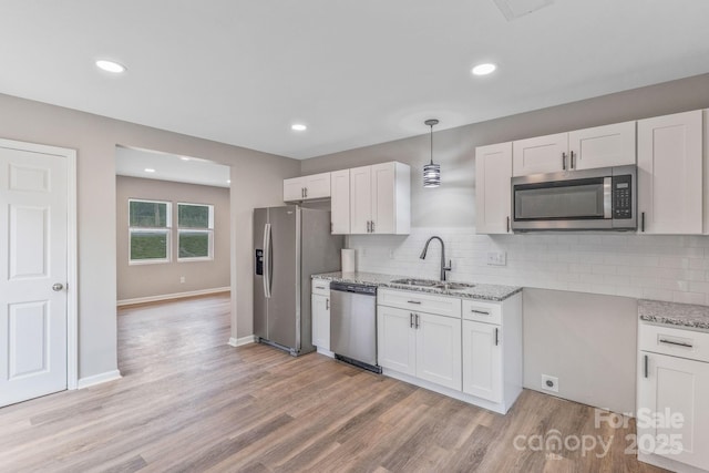 2511 Linwood Rd, Gastonia, NC 28052 - kitchen with a sink, appliances with stainless steel finishes, light stone countertops, decorative backsplash, and white cabinets