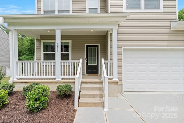 7308 Rothmore St, Charlotte, NC 28215 - entrance to property featuring covered porch, a garage, and concrete driveway