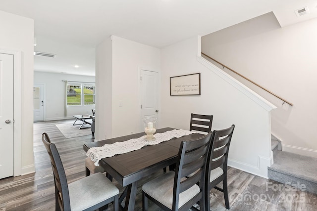7308 Rothmore St, Charlotte, NC 28215 - dining room featuring wood finished floors, stairway, and baseboards
