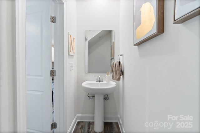 7308 Rothmore St, Charlotte, NC 28215 - bathroom with baseboards, wood finished floors, and a sink