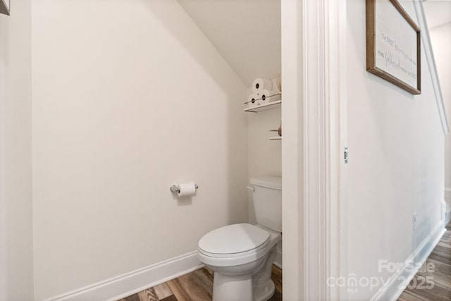7308 Rothmore St, Charlotte, NC 28215 - bathroom with wood finished floors, toilet, baseboards, and lofted ceiling