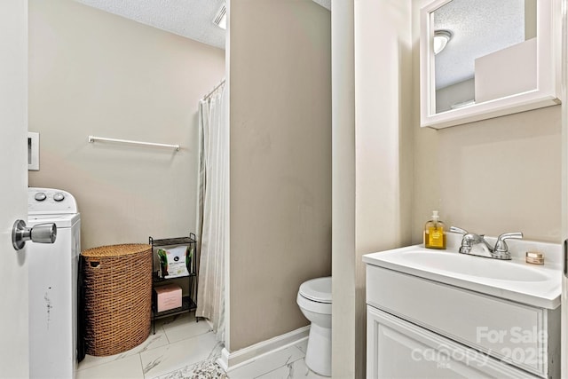bathroom with marble look tile flooring, toilet, washer / clothes dryer, a shower with curtain, and vanity