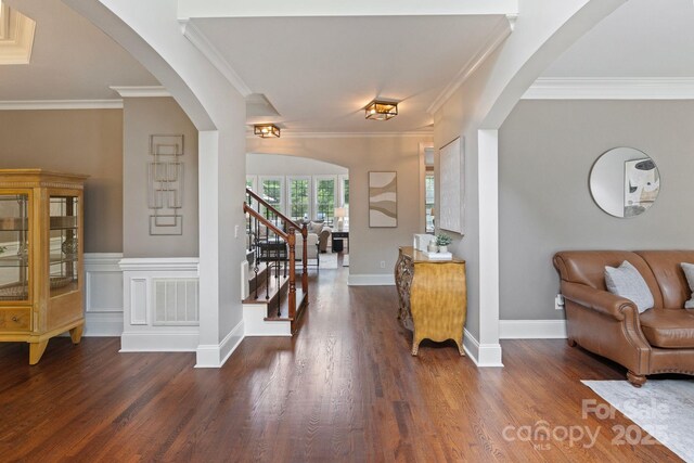 9433 Wallace Pond Dr, Huntersville, NC 28078 - entryway with arched walkways, wood finished floors, stairway, ornamental molding, and baseboards
