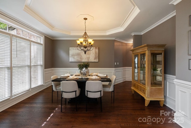 9433 Wallace Pond Dr, Huntersville, NC 28078 - dining space with a chandelier, a raised ceiling, a wainscoted wall, ornamental molding, and dark wood-style floors
