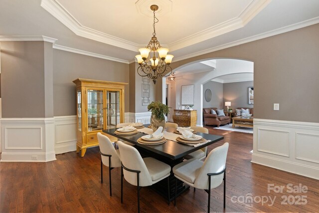 9433 Wallace Pond Dr, Huntersville, NC 28078 - dining space with arched walkways, a chandelier, dark wood finished floors, wainscoting, and ornamental molding
