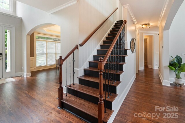 9433 Wallace Pond Dr, Huntersville, NC 28078 - staircase featuring arched walkways, wood finished floors, and ornamental molding