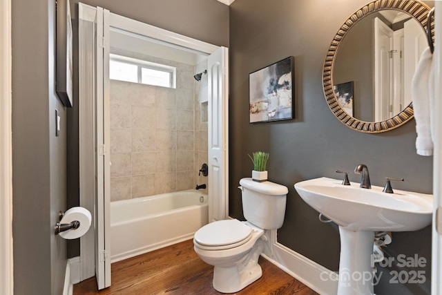 9433 Wallace Pond Dr, Huntersville, NC 28078 - bathroom featuring toilet, shower / bathtub combination, wood finished floors, and baseboards
