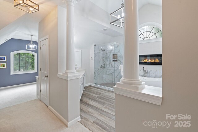 9433 Wallace Pond Dr, Huntersville, NC 28078 - corridor featuring decorative columns, vaulted ceiling, light colored carpet, and baseboards