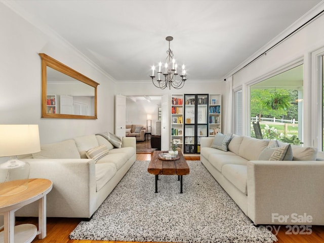 1031 Eldorado Ave, Charlotte, NC 28262 - living room with ornamental molding, a chandelier, and wood finished floors