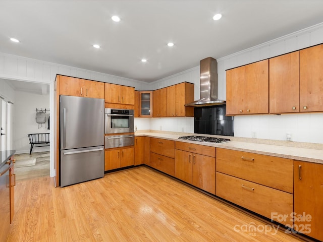 1031 Eldorado Ave, Charlotte, NC 28262 - kitchen featuring stainless steel appliances, a warming drawer, wall chimney range hood, light wood-type flooring, and light countertops