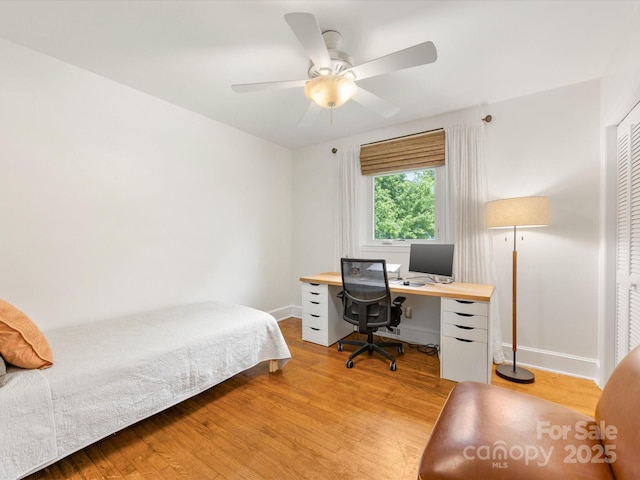 1031 Eldorado Ave, Charlotte, NC 28262 - bedroom with light wood-style flooring, baseboards, an office area, and a ceiling fan