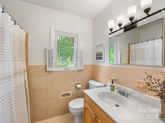 1031 Eldorado Ave, Charlotte, NC 28262 - full bath featuring toilet, tile walls, a wainscoted wall, vanity, and tile patterned flooring